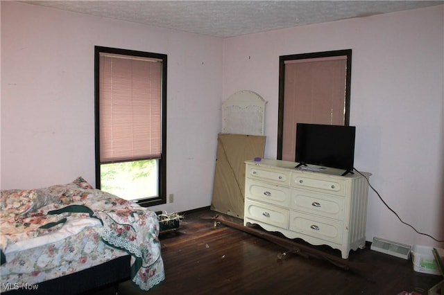 635 N Hametown Rd, Akron, OH 44333 - bedroom with dark wood-type flooring and a textured ceiling