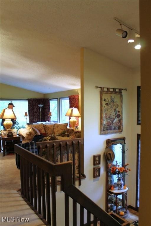 635 N Hametown Rd, Akron, OH 44333 - hallway featuring vaulted ceiling, an upstairs landing, and track lighting