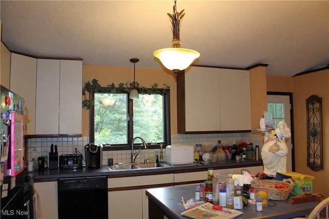 635 N Hametown Rd, Akron, OH 44333 - kitchen with black dishwasher, a sink, dark countertops, backsplash, and pendant lighting