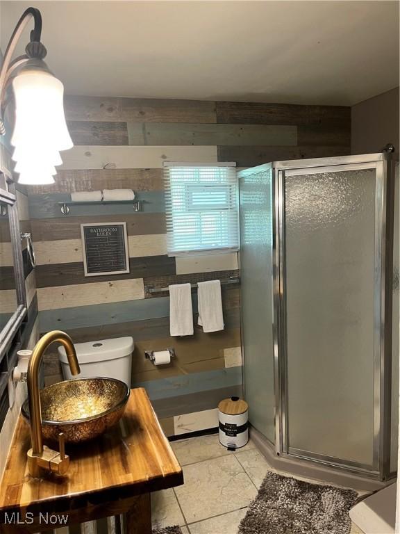 1264 Diagonal Rd, Akron, OH 44307 - bathroom with a stall shower, a sink, wood walls, and toilet