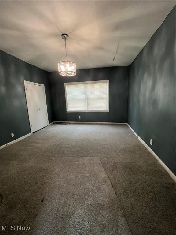1264 Diagonal Rd, Akron, OH 44307 - carpeted empty room featuring a chandelier and baseboards