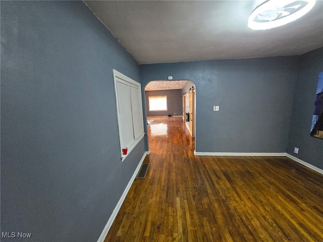 1264 Diagonal Rd, Akron, OH 44307 - unfurnished room with arched walkways, hardwood / wood-style floors, and baseboards