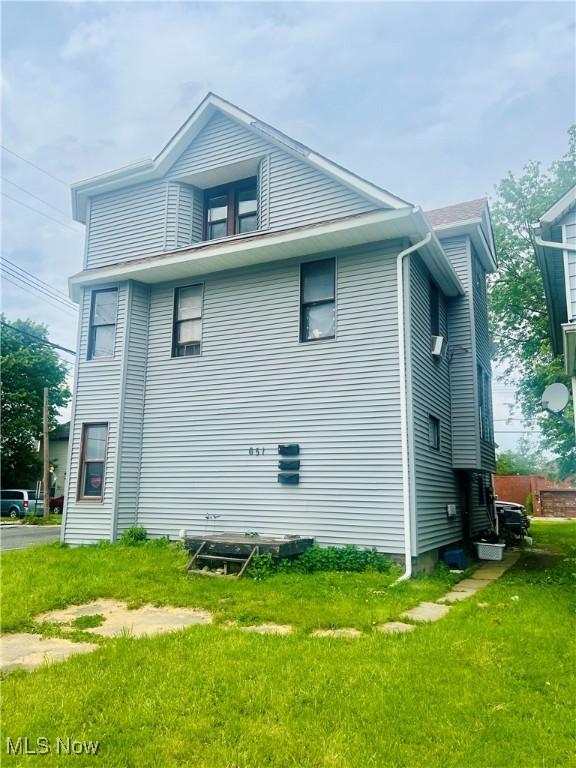 651 Wooster Rd W, Barberton, OH 44203 - view of side of property featuring a lawn