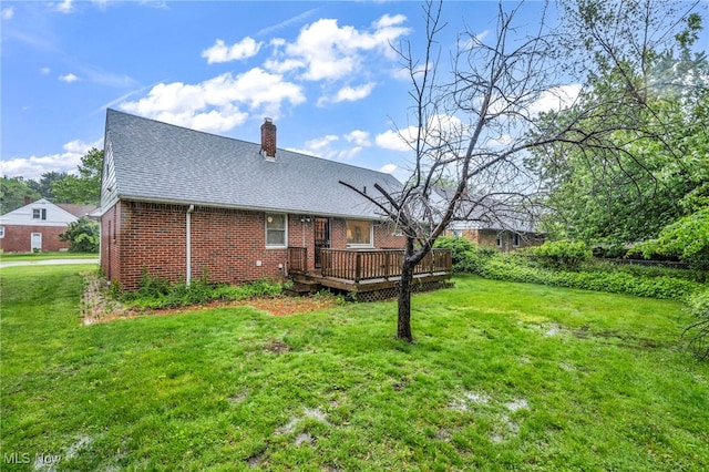313 E 244th St, Euclid, OH 44123 - back of house with brick siding, a deck, a chimney, and a yard