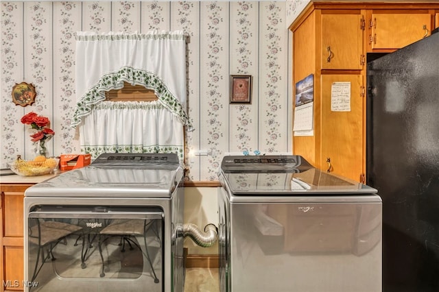313 E 244th St, Euclid, OH 44123 - laundry area featuring wallpapered walls, cabinet space, and separate washer and dryer