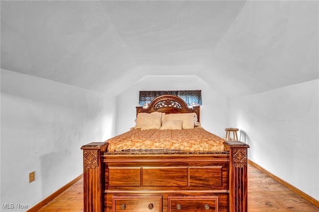 313 E 244th St, Euclid, OH 44123 - bedroom with light wood-style floors, lofted ceiling, and baseboards