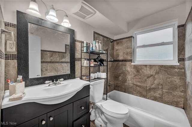 1654 Vicgross Ave, Akron, OH 44310 - full bath with toilet, vanity, bathing tub / shower combination, and tile walls