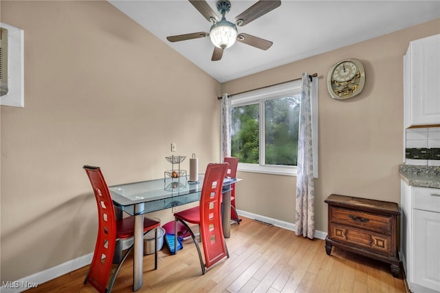 1654 Vicgross Ave, Akron, OH 44310 - dining space with baseboards, a ceiling fan, vaulted ceiling, and light wood-type flooring