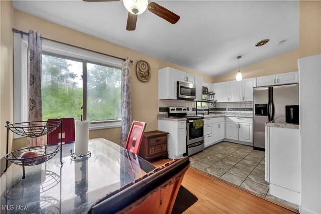 1654 Vicgross Ave, Akron, OH 44310 - kitchen featuring stainless steel appliances, ceiling fan, white cabinets, tasteful backsplash, and light countertops