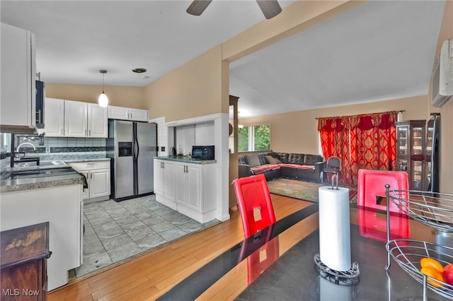 1654 Vicgross Ave, Akron, OH 44310 - kitchen featuring stainless steel fridge, white cabinetry, light wood finished floors, ceiling fan, and backsplash