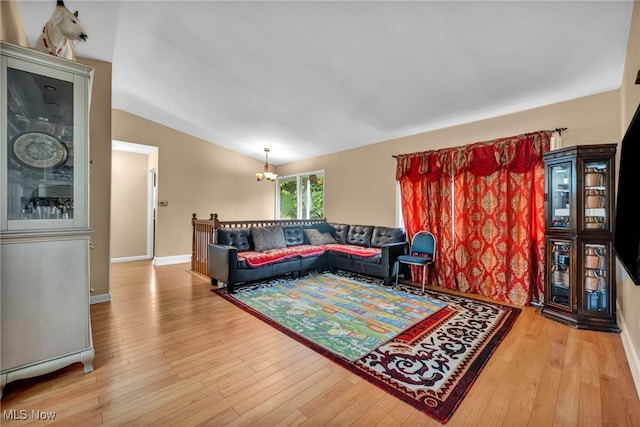 1654 Vicgross Ave, Akron, OH 44310 - living room featuring hardwood / wood-style flooring, a chandelier, vaulted ceiling, and baseboards