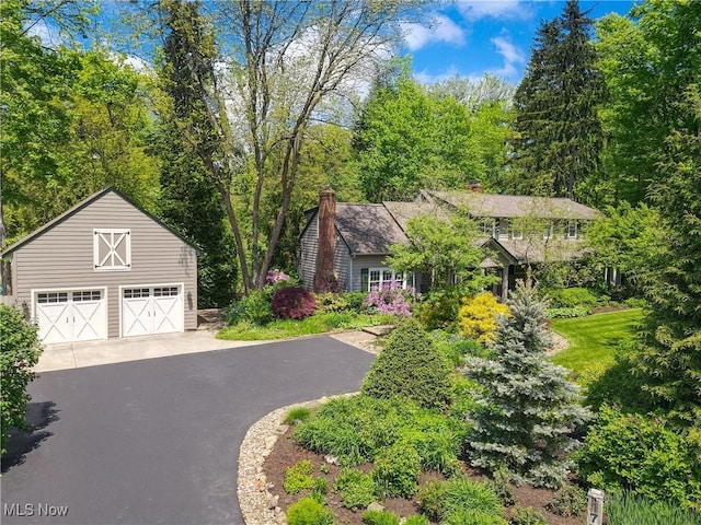 7700 Clarion Dr, Chagrin Falls, OH 44022 - view of front of house featuring a detached garage, an outbuilding, and a chimney