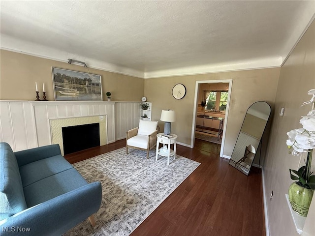 1089 Homestead Rd, South Euclid, OH 44121 - living room featuring dark wood-type flooring, a fireplace, baseboards, a textured ceiling, and ornamental molding