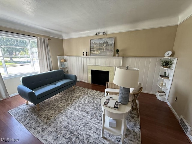 1089 Homestead Rd, South Euclid, OH 44121 - living area featuring a fireplace, wood finished floors, and crown molding