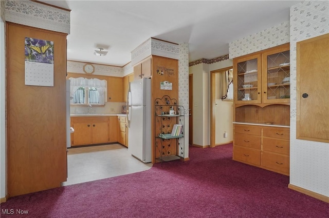 1783 Depot Rd, Salem, OH 44460 - kitchen featuring wallpapered walls, freestanding refrigerator, light countertops, glass insert cabinets, and carpet floors