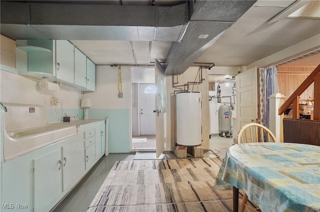 1783 Depot Rd, Salem, OH 44460 - kitchen featuring water heater, wood finished floors, white cabinets, and light countertops