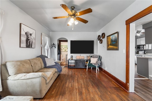 2445 Pigeon Run Rd SW, Massillon, OH 44647 - living area featuring ceiling fan, dark wood finished floors, baseboards, and arched walkways