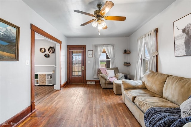2445 Pigeon Run Rd SW, Massillon, OH 44647 - living room featuring wood-type flooring, baseboards, and ceiling fan