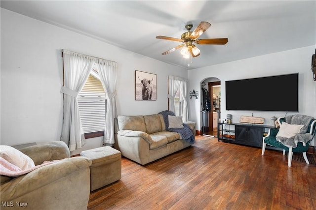 2445 Pigeon Run Rd SW, Massillon, OH 44647 - living room with healthy amount of natural light, arched walkways, ceiling fan, and wood-type flooring