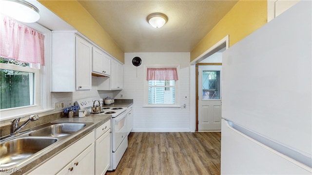 2364 Suncrest Dr, Cuyahoga Falls, OH 44221 - kitchen with white appliances, a sink, white cabinetry, wood finished floors, and baseboards
