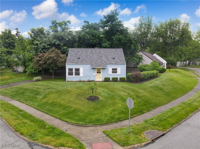 2364 Suncrest Dr, Cuyahoga Falls, OH 44221 - view of front facade featuring a front lawn, roof with shingles, and view of scattered trees