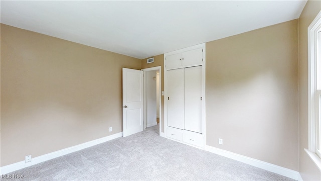 2364 Suncrest Dr, Cuyahoga Falls, OH 44221 - unfurnished bedroom with light carpet, baseboards, and a closet