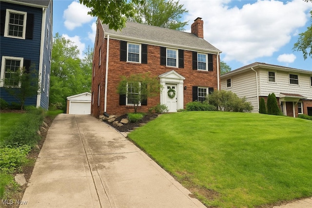 3945 Meadowbrook Blvd, University Heights, OH 44118 - colonial house with a chimney, an outbuilding, brick siding, and a garage
