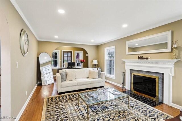 3945 Meadowbrook Blvd, University Heights, OH 44118 - living area featuring arched walkways, ornamental molding, recessed lighting, a fireplace with flush hearth, and baseboards