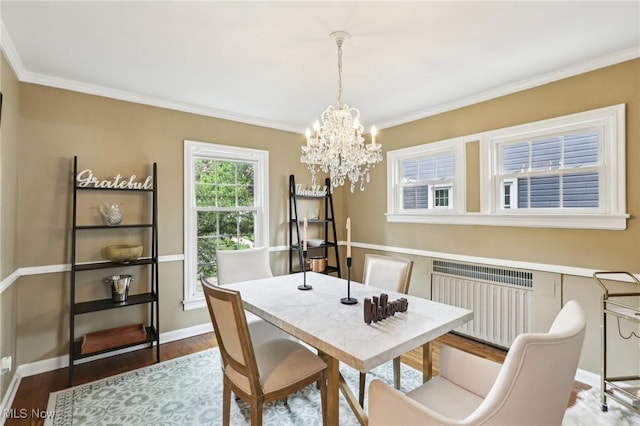 3945 Meadowbrook Blvd, University Heights, OH 44118 - dining space featuring radiator heating unit, crown molding, a chandelier, wood finished floors, and baseboards