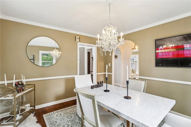 3945 Meadowbrook Blvd, University Heights, OH 44118 - dining area featuring wood finished floors, arched walkways, crown molding, a chandelier, and baseboards