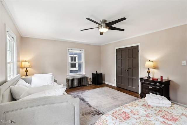 3945 Meadowbrook Blvd, University Heights, OH 44118 - bedroom with radiator heating unit, dark wood-style flooring, multiple windows, baseboards, and ornamental molding