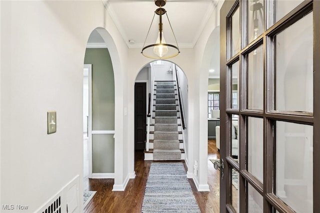 3945 Meadowbrook Blvd, University Heights, OH 44118 - foyer entrance featuring crown molding, dark wood-style flooring, stairway, arched walkways, and baseboards