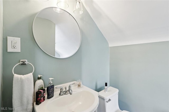 3945 Meadowbrook Blvd, University Heights, OH 44118 - half bath featuring a sink, toilet, and lofted ceiling