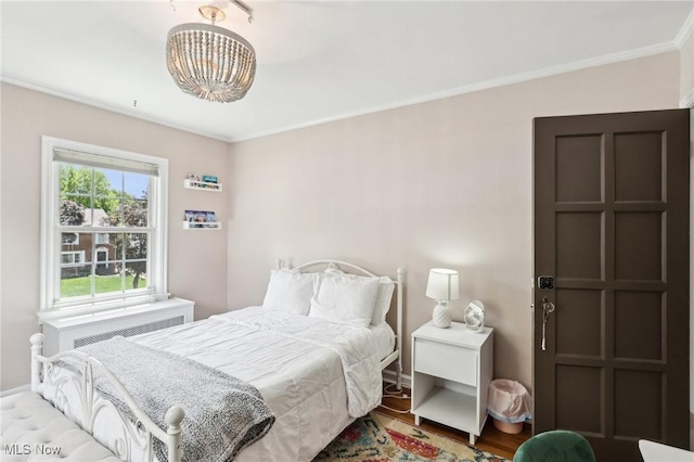3945 Meadowbrook Blvd, University Heights, OH 44118 - bedroom with a chandelier, ornamental molding, baseboards, and wood finished floors