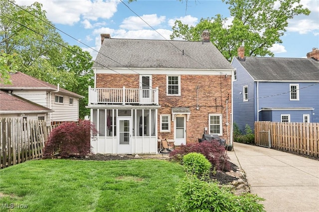 3945 Meadowbrook Blvd, University Heights, OH 44118 - back of house featuring a balcony, brick siding, concrete driveway, and a chimney