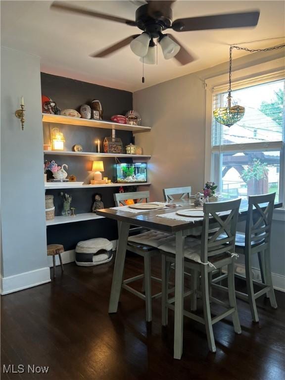 724 8th St, Struthers, OH 44471 - dining space featuring wood finished floors, a ceiling fan, and baseboards