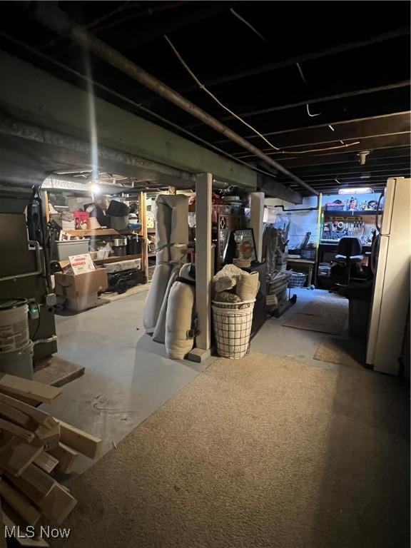 724 8th St, Struthers, OH 44471 - unfinished basement featuring freestanding refrigerator