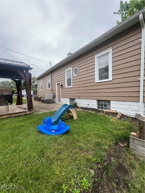 724 8th St, Struthers, OH 44471 - rear view of property featuring a gazebo, a wooden deck, and a yard