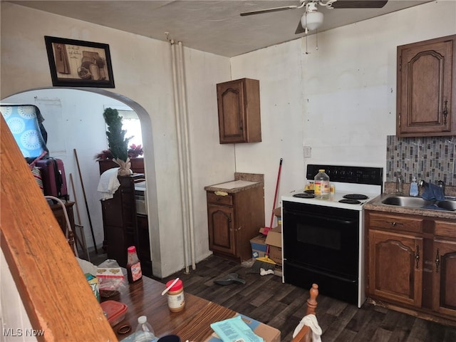 308 10th St, Wellsville, OH 43968 - kitchen with electric range oven, ceiling fan, dark wood-style flooring, tasteful backsplash, and a sink
