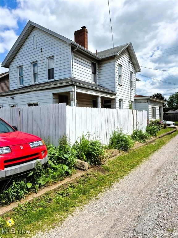 308 10th St, Wellsville, OH 43968 - view of side of property with a chimney