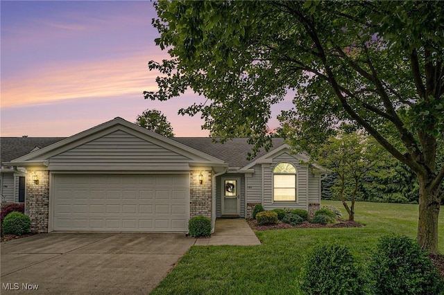 194 Lisa Ann Dr, Huron, OH 44839 - ranch-style house with an attached garage, driveway, a yard, and brick siding