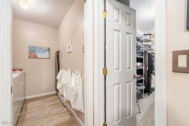 194 Lisa Ann Dr, Huron, OH 44839 - hall featuring washer and dryer, baseboards, and a textured ceiling