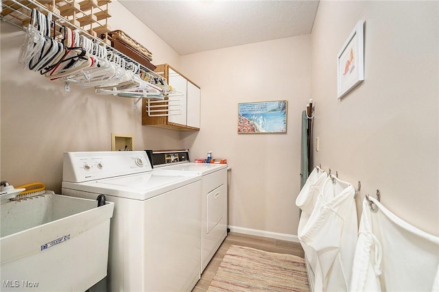 194 Lisa Ann Dr, Huron, OH 44839 - laundry area with washing machine and dryer, a sink, light wood finished floors, and baseboards
