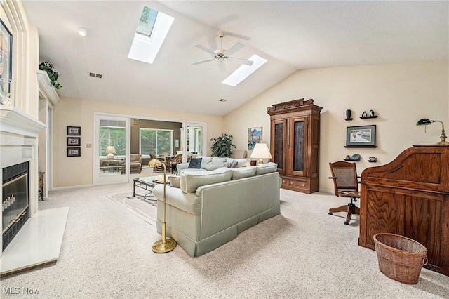 194 Lisa Ann Dr, Huron, OH 44839 - living area with a skylight, a high end fireplace, vaulted ceiling, carpet flooring, and a ceiling fan