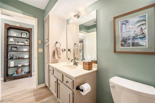 194 Lisa Ann Dr, Huron, OH 44839 - half bath with vanity, toilet, wood finished floors, and baseboards
