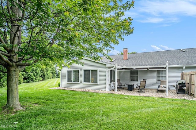 194 Lisa Ann Dr, Huron, OH 44839 - rear view of property with a patio, a chimney, and roof with shingles