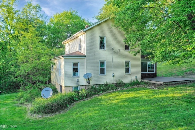 5981 Westfall St SE, Waynesburg, OH 44688 - back of house with a wooden deck, a lawn, and a chimney