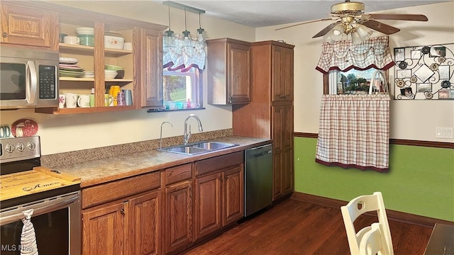 5981 Westfall St SE, Waynesburg, OH 44688 - kitchen featuring appliances with stainless steel finishes, a sink, ceiling fan, dark wood-style flooring, and brown cabinetry
