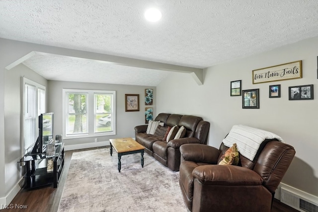 3136 Ellet Ave, Akron, OH 44312 - living room with wood finished floors, a textured ceiling, and baseboards