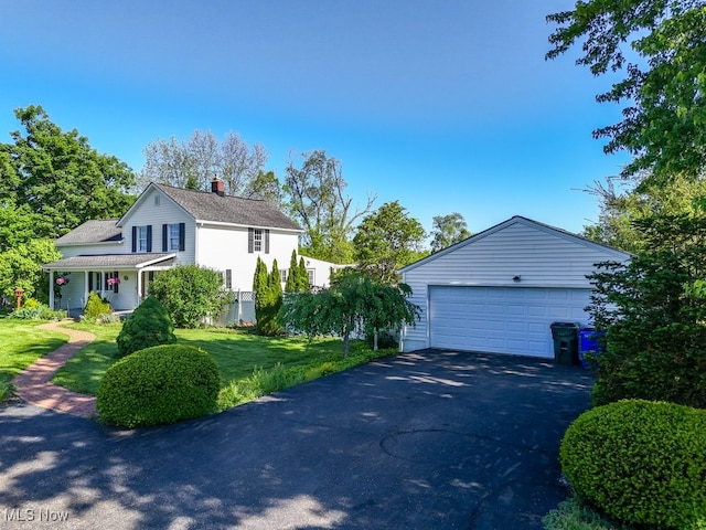 869 State Route 303, Streetsboro, OH 44241 - view of side of home featuring a chimney, a lawn, a detached garage, and a shingled roof